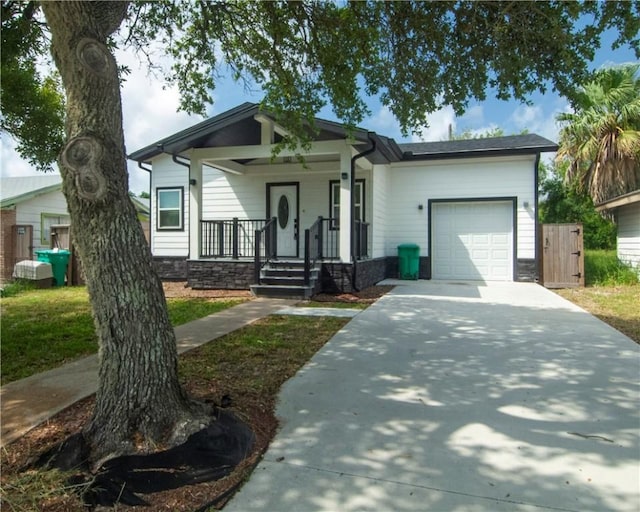 607 Matlock, Aransas Pass, TX 78336 - view of front of home with a garage, concrete driveway, and a porch