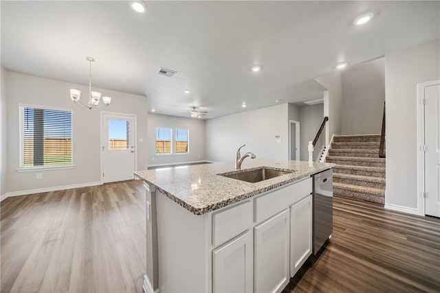 kitchen with sink, a center island with sink, decorative light fixtures, white cabinets, and hardwood / wood-style floors