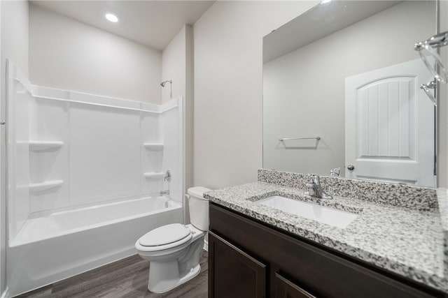 full bathroom with toilet, vanity, wood-type flooring, and tub / shower combination