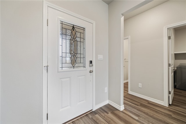 foyer with washing machine and dryer and dark hardwood / wood-style flooring