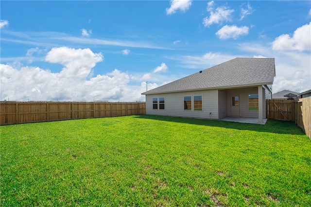 rear view of property featuring a patio area and a lawn