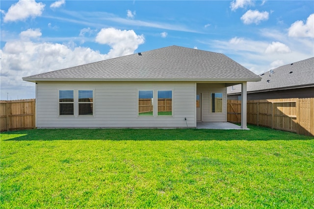 back of house featuring a lawn and a patio