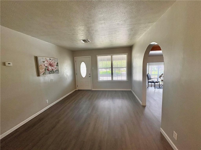 1230 Dona, Corpus Christi, TX 78407 - foyer with dark wood finished floors, a textured ceiling, and arched walkways