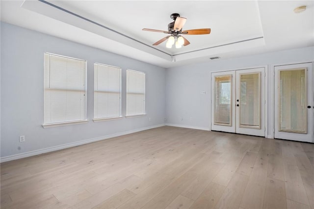 1003 S Pearl St, Rockport, TX 78382 - empty room featuring a tray ceiling, ceiling fan, baseboards, and a smoke detector