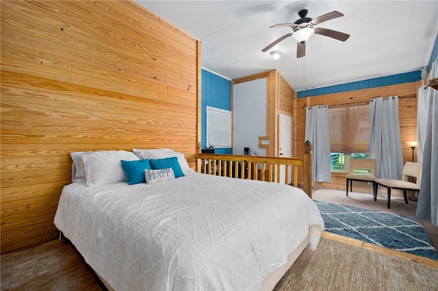 1003 S Pearl St, Rockport, TX 78382 - carpeted bedroom featuring wood walls and a ceiling fan