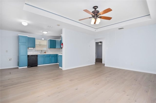 1003 S Pearl St, Rockport, TX 78382 - unfurnished living room with ceiling fan, light wood-style floors, baseboards, and a raised ceiling