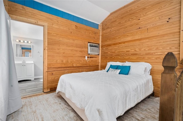 1003 S Pearl St, Rockport, TX 78382 - bedroom with wooden walls, lofted ceiling, a wall unit AC, wood finished floors, and ensuite bath