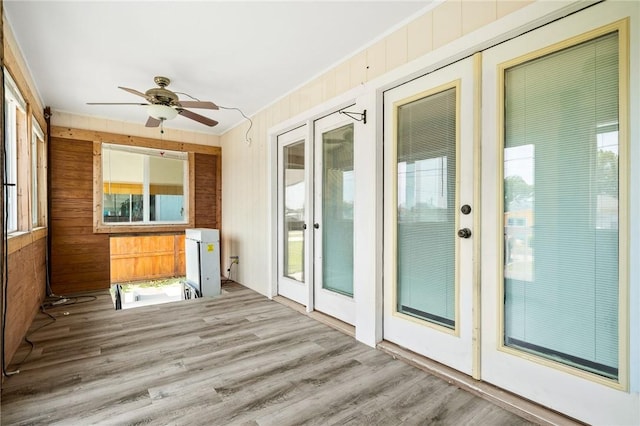 1003 S Pearl St, Rockport, TX 78382 - unfurnished sunroom featuring wood finished floors and wood walls