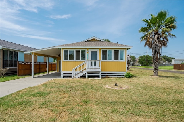 view of front of property featuring a carport and a front lawn