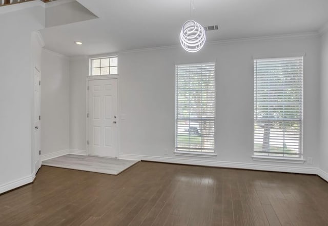 foyer entrance with dark hardwood / wood-style flooring and crown molding