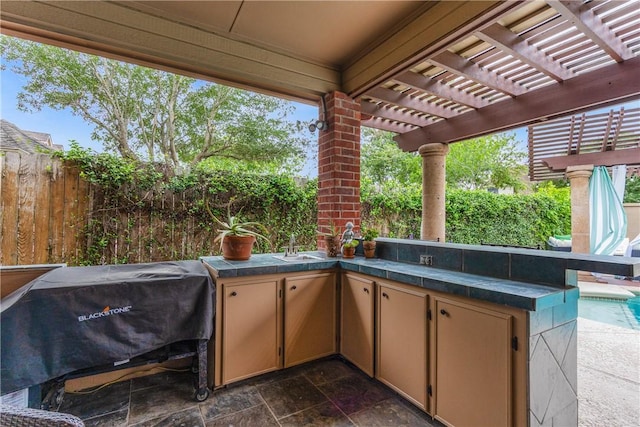 7001 Bevington Dr, Corpus Christi, TX 78413 - view of patio featuring a fenced backyard, grilling area, area for grilling, a pergola, and a sink