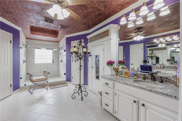 7001 Bevington Dr, Corpus Christi, TX 78413 - bathroom with ornamental molding, a ceiling fan, tiled shower, tile patterned flooring, and vanity