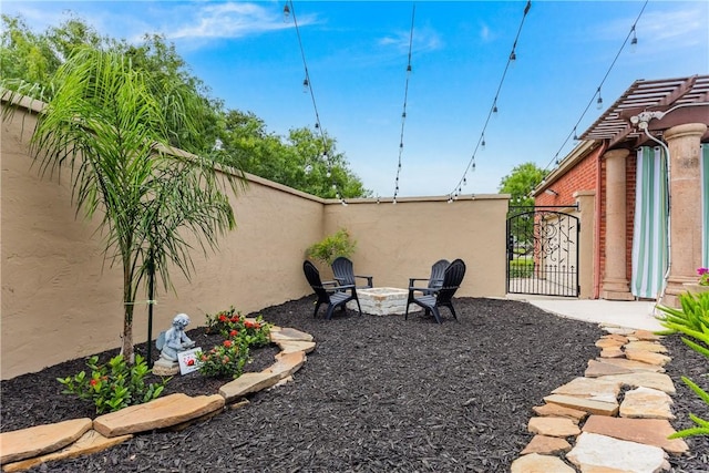 7001 Bevington Dr, Corpus Christi, TX 78413 - view of yard featuring fence, a fire pit, and a gate