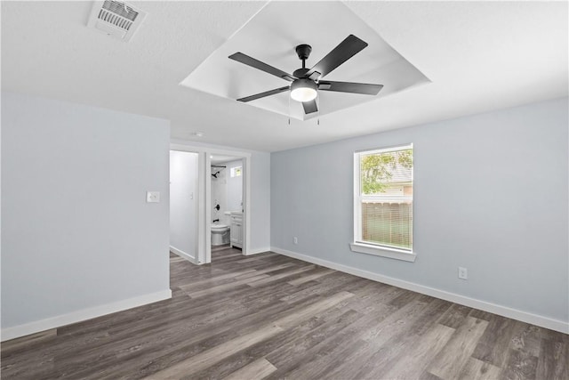 2845 Elgin St, Corpus Christi, TX 78405 - unfurnished room with dark wood-style flooring, ceiling fan, and a tray ceiling