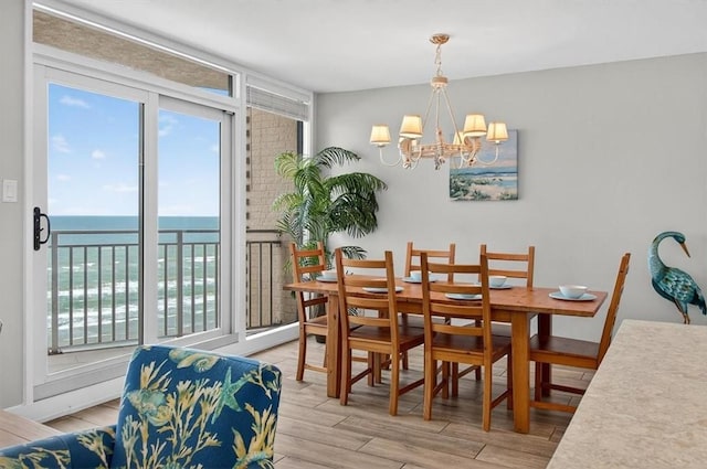 6649 Seacomber Dr Unit 807, Port Aransas, TX 78373 - dining space featuring light wood finished floors, a chandelier, and a water view