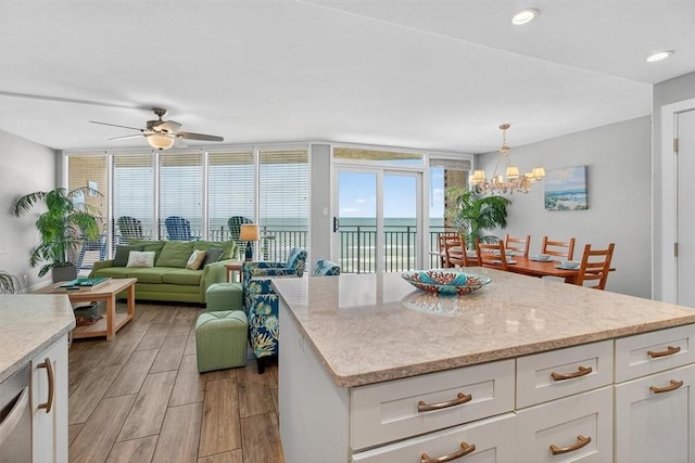 6649 Seacomber Dr Unit 807, Port Aransas, TX 78373 - kitchen featuring light wood-type flooring, white cabinetry, a ceiling fan, a chandelier, and decorative light fixtures