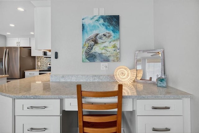 6649 Seacomber Dr Unit 807, Port Aransas, TX 78373 - kitchen with stainless steel appliances, tasteful backsplash, white cabinets, light stone countertops, and recessed lighting