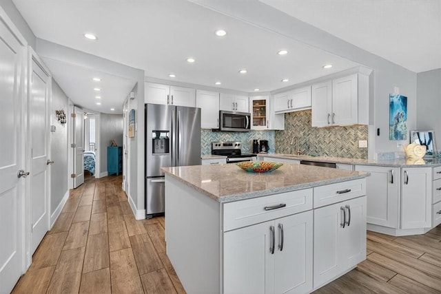 6649 Seacomber Dr Unit 807, Port Aransas, TX 78373 - kitchen featuring appliances with stainless steel finishes, backsplash, light wood-style flooring, and recessed lighting