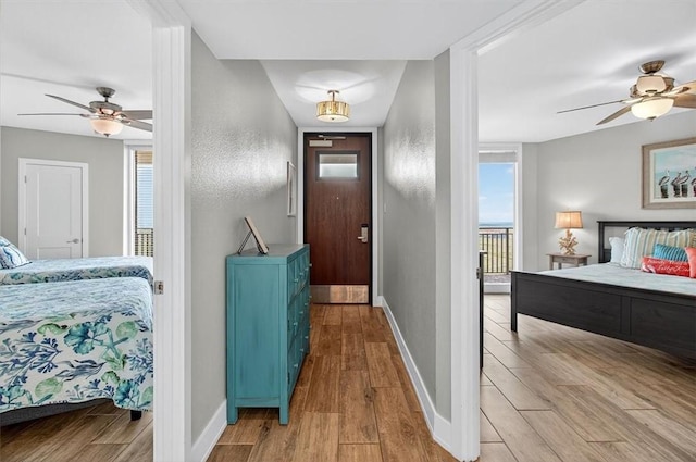 6649 Seacomber Dr Unit 807, Port Aransas, TX 78373 - bedroom featuring wood finished floors, multiple windows, and a ceiling fan