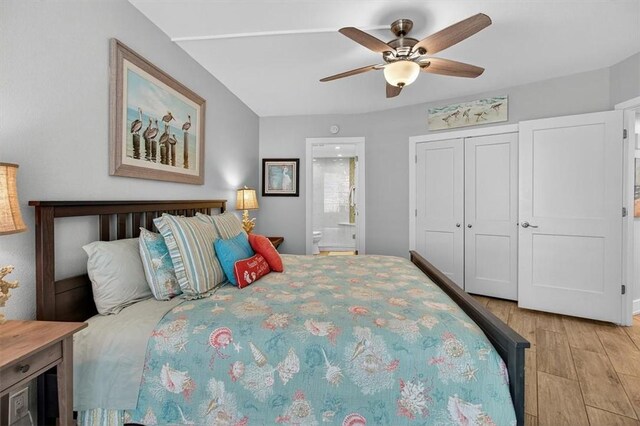 6649 Seacomber Dr Unit 807, Port Aransas, TX 78373 - bedroom featuring light wood-style flooring, ensuite bath, a ceiling fan, and a closet