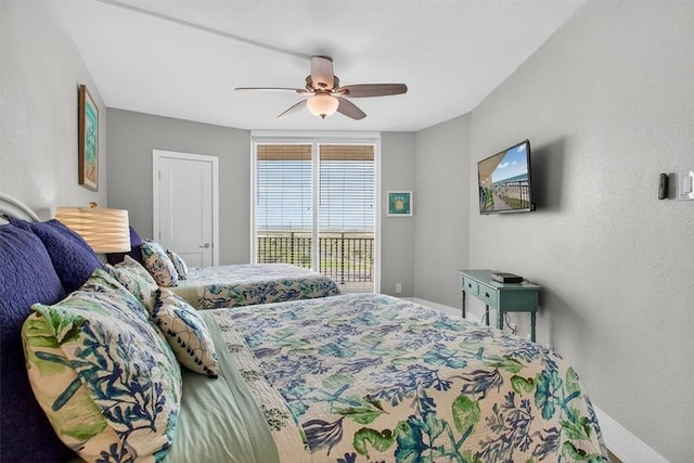 6649 Seacomber Dr Unit 807, Port Aransas, TX 78373 - bedroom with access to exterior and ceiling fan
