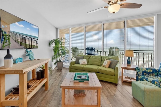 6649 Seacomber Dr Unit 807, Port Aransas, TX 78373 - living area with a ceiling fan, light wood finished floors, and expansive windows