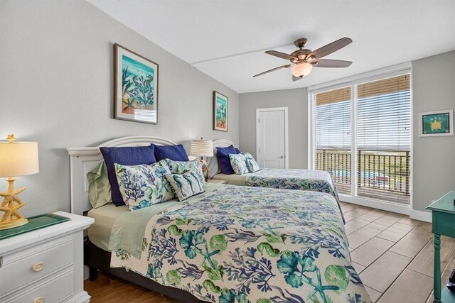 6649 Seacomber Dr Unit 807, Port Aransas, TX 78373 - bedroom with access to outside, a ceiling fan, and tile patterned flooring