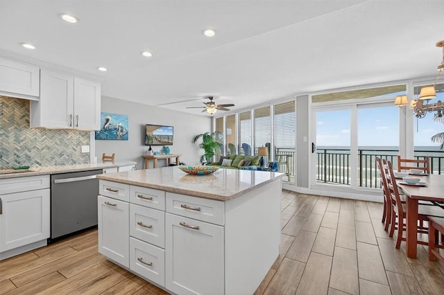 6649 Seacomber Dr Unit 807, Port Aransas, TX 78373 - kitchen featuring stainless steel dishwasher, decorative backsplash, light wood-style flooring, ceiling fan, and white cabinets
