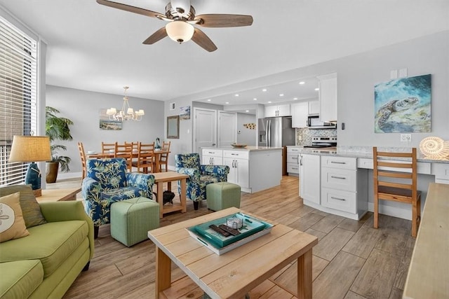 6649 Seacomber Dr Unit 807, Port Aransas, TX 78373 - living area featuring light wood-style flooring, ceiling fan, a chandelier, a desk, and recessed lighting