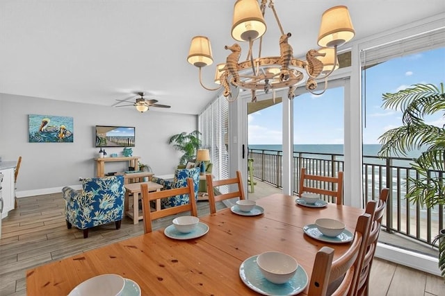 6649 Seacomber Dr Unit 807, Port Aransas, TX 78373 - dining area featuring a ceiling fan, wood finished floors, and a chandelier