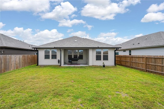 back of house featuring a patio, a fenced backyard, and a lawn