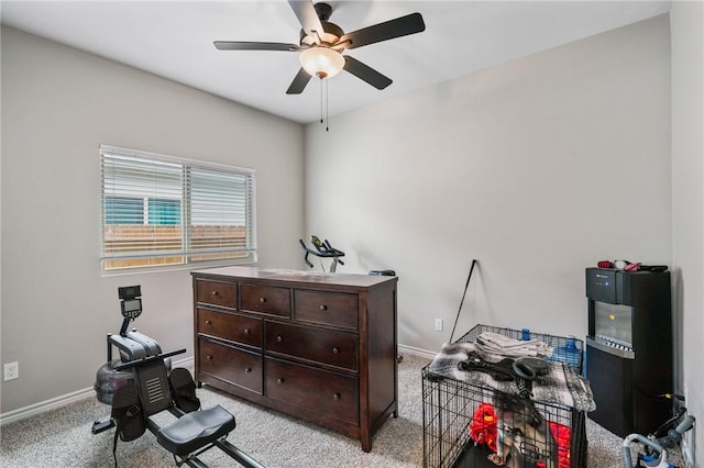misc room with baseboards, ceiling fan, and light carpet