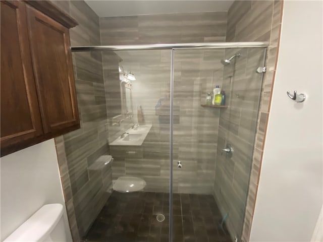 bathroom with an enclosed shower and toilet