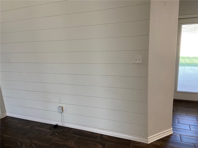 interior space with wood walls and wood-type flooring