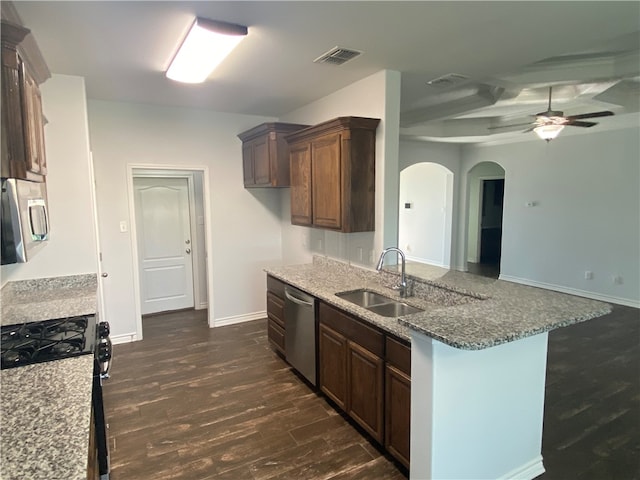 kitchen with sink, dark hardwood / wood-style floors, ceiling fan, stone countertops, and stainless steel appliances