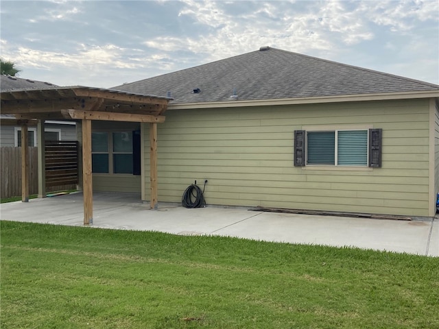 rear view of house with a patio area and a lawn