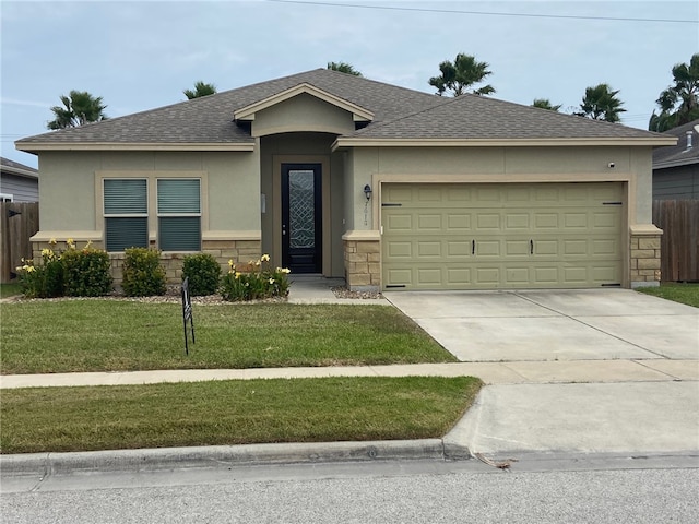 ranch-style home with a garage and a front lawn