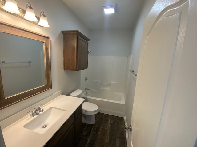 full bathroom with hardwood / wood-style floors, vanity, shower / bathtub combination, and toilet