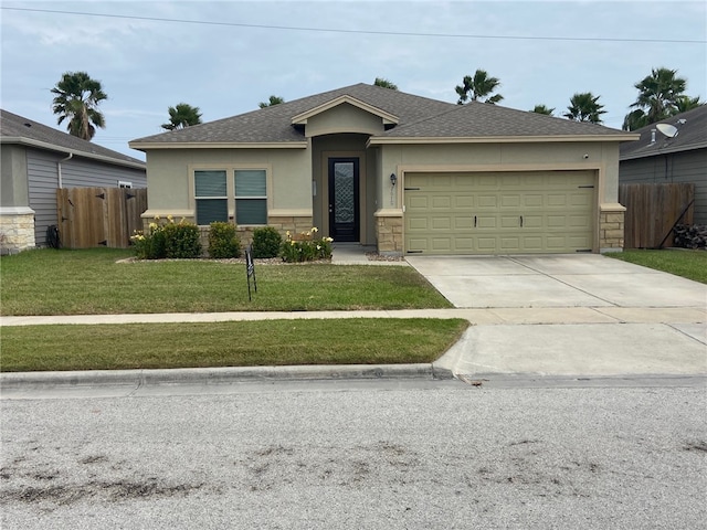 view of front of house featuring a front yard and a garage