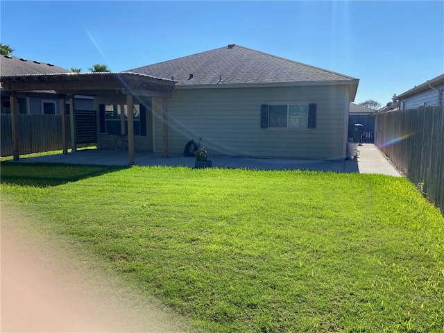 back of house featuring a yard and a patio