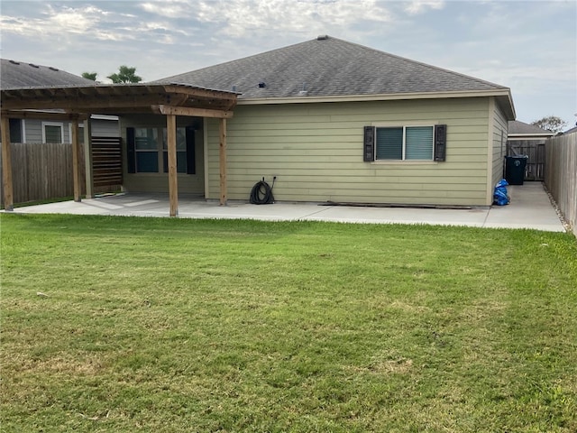 rear view of property with a lawn and a patio