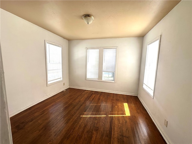 unfurnished room featuring dark hardwood / wood-style flooring