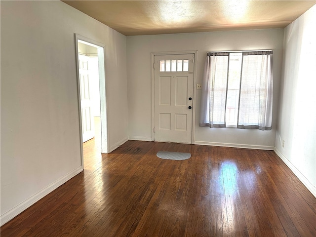 entryway with dark hardwood / wood-style flooring