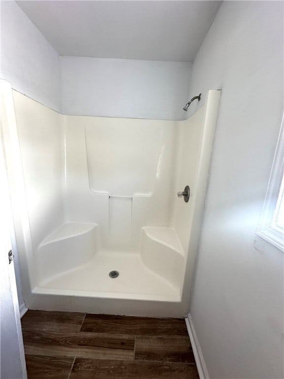 bathroom with wood-type flooring and a shower