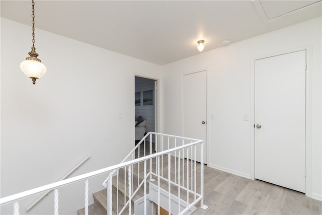 corridor with light hardwood / wood-style floors