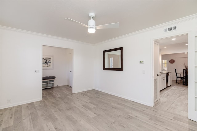 spare room with light wood-type flooring, ceiling fan, and ornamental molding