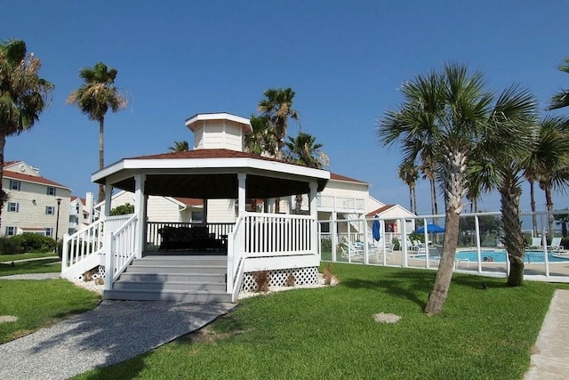 exterior space with a front yard, a swimming pool side deck, and a gazebo