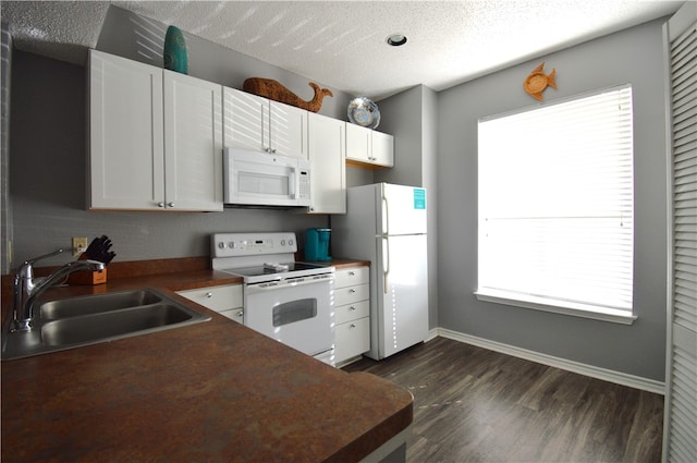 kitchen with white cabinetry, white appliances, sink, and a healthy amount of sunlight