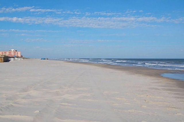 property view of water featuring a beach view