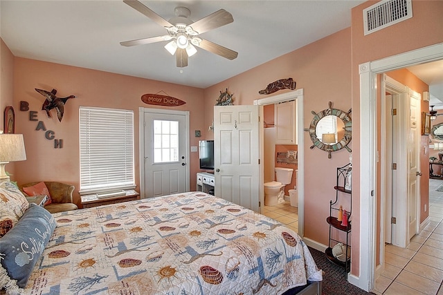 141 Mustang Royale Blvd, Port Aransas, TX 78373 - bedroom with light tile patterned floors, ensuite bath, ceiling fan, and baseboards